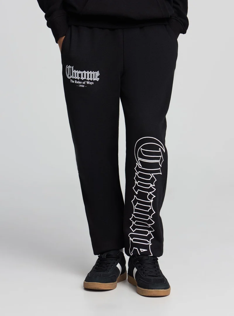Pantaloni tuta con stampa gotica
