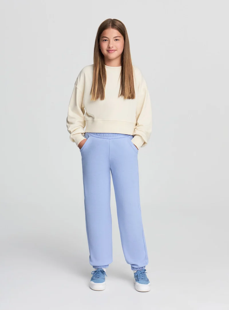 Pantaloni tuta tinta unita con polsini