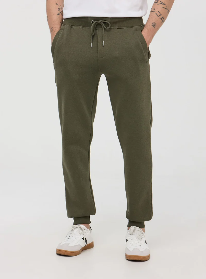Pantaloni tuta pesanti con coulisse e polsini