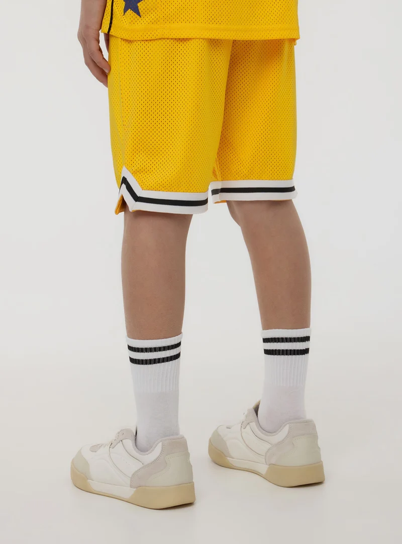 Pantaloncini in rete stile basket