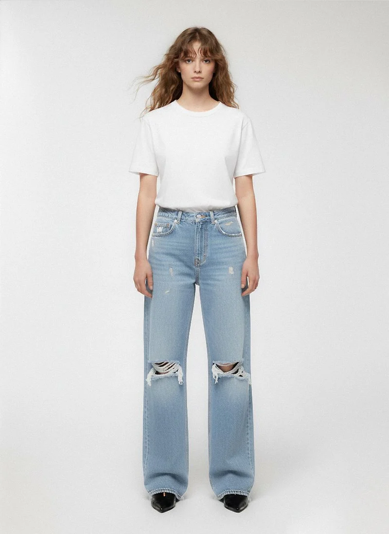 Jeans chiari wide leg con strappi