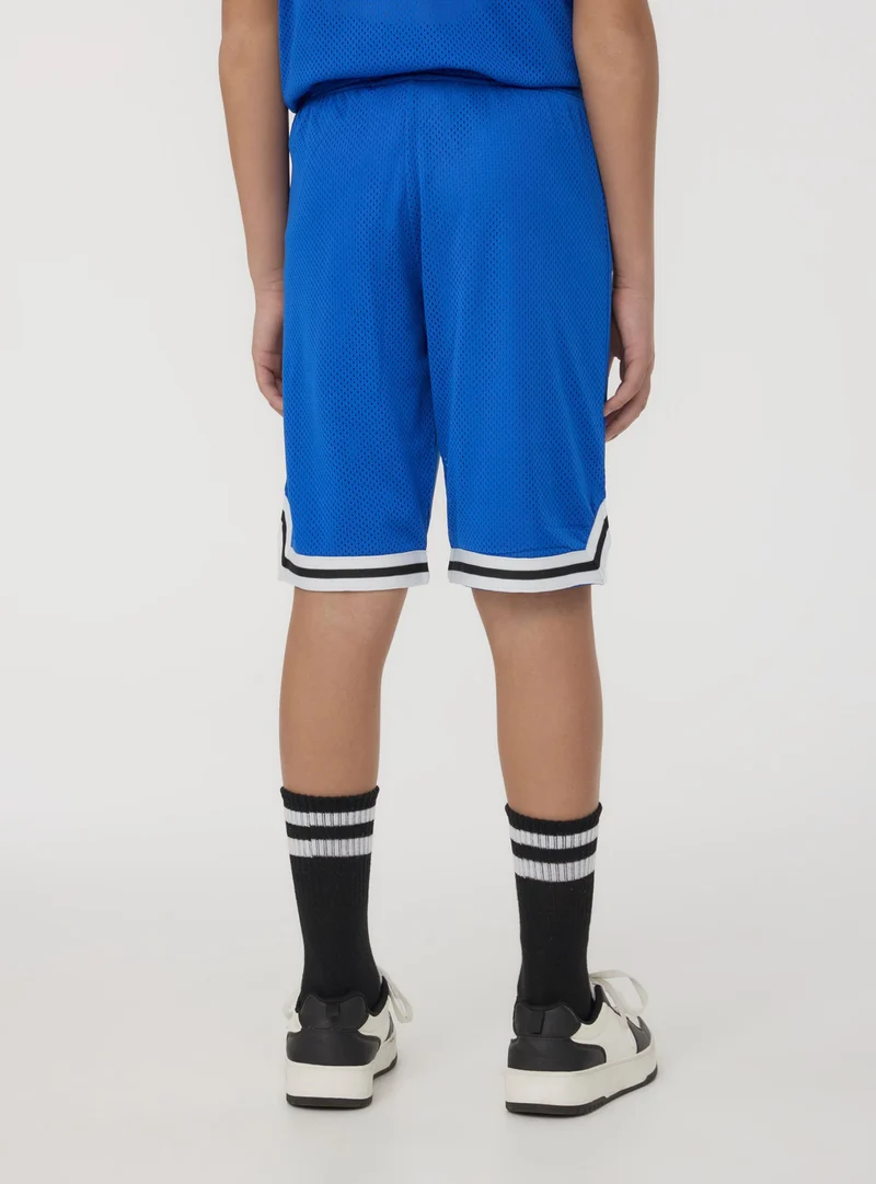 Pantaloncini in rete stile basket