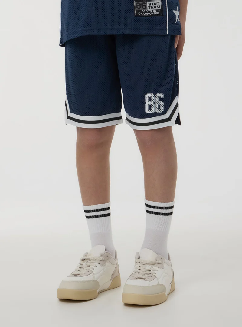 Pantaloncini in rete stile basket