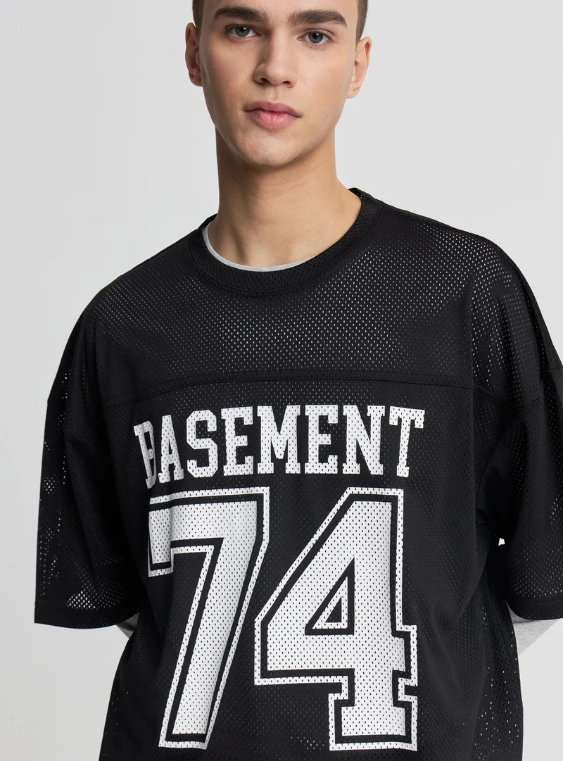 T-shirt boxy fit a rete con stampa