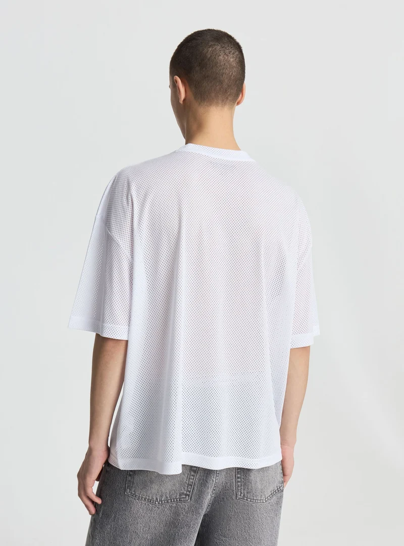 T-shirt boxy fit a rete con stampa
