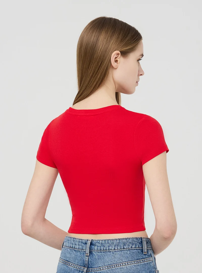 T-shirt crop aderente tinta unita