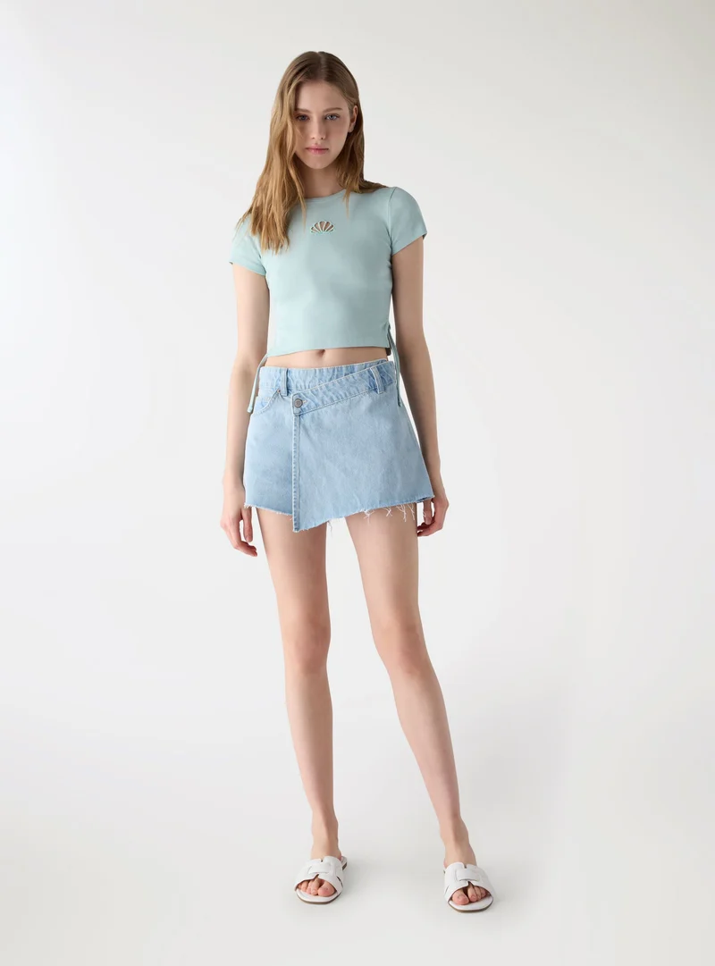 T-shirt crop con coulisse laterali e ricamo conchiglia