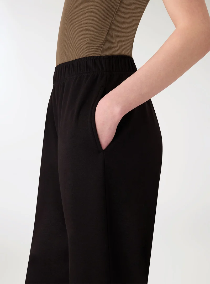 Pantaloni tuta wide leg a tinta unita