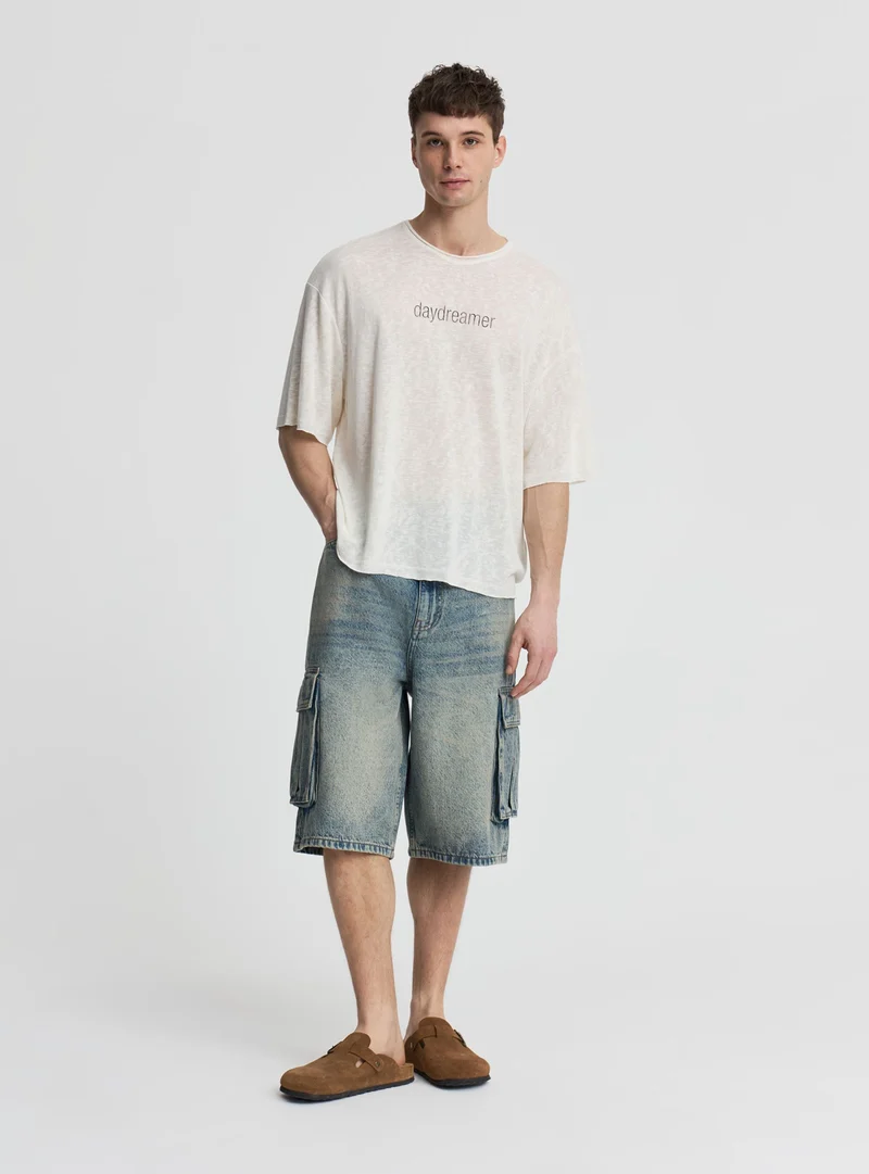 Pantaloncini jeans cargo super baggy a tinta unita