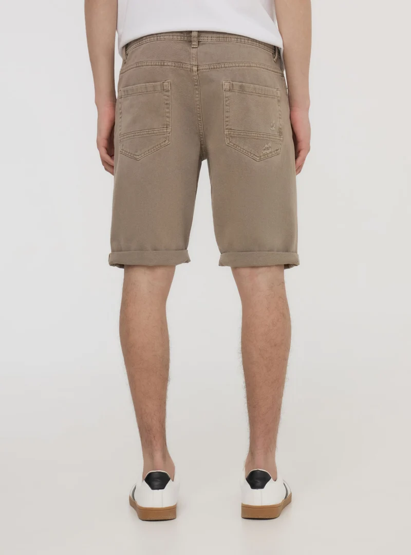 Bermuda in denim con strappi