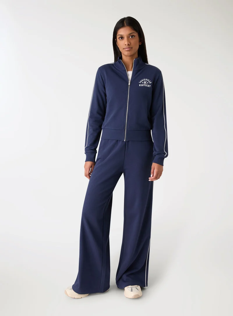 Pantaloni tuta wide leg con bande laterali
