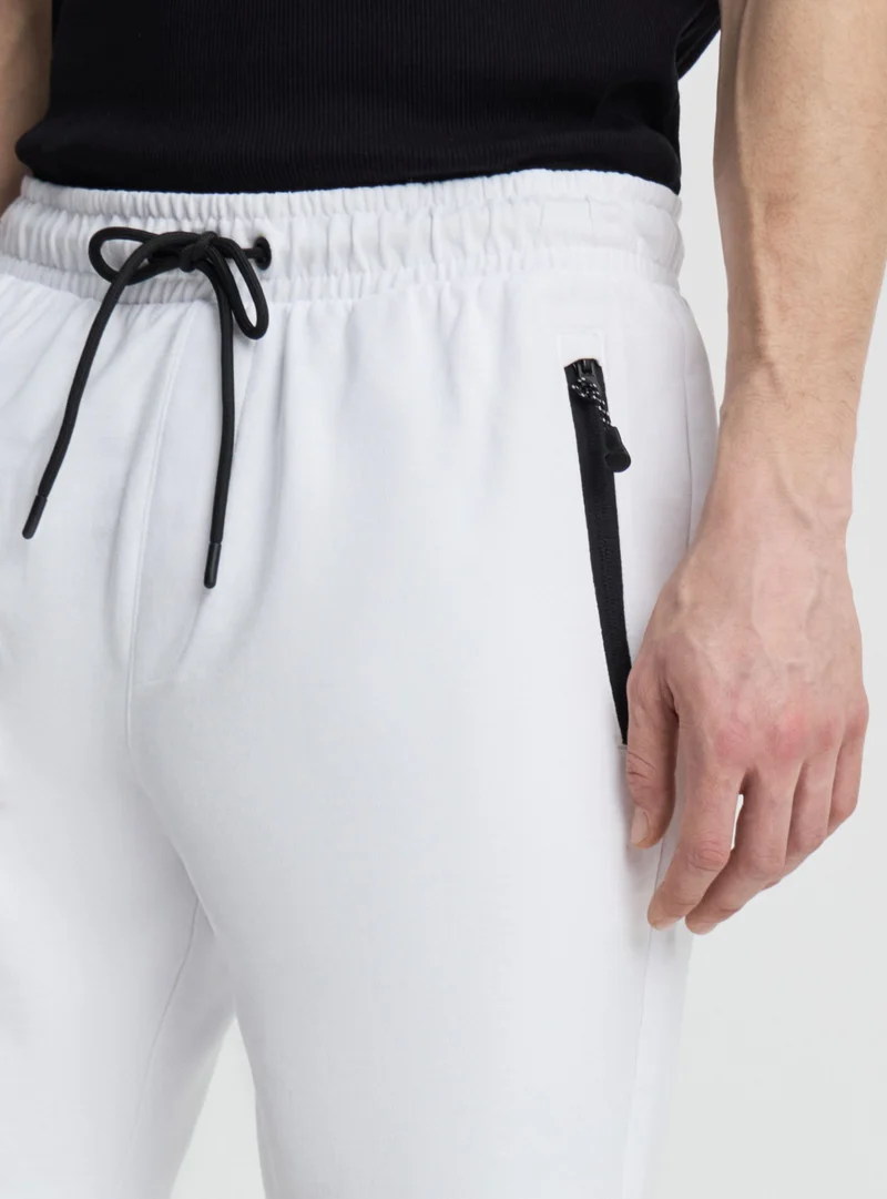 Bermuda tecnico con tasche zip