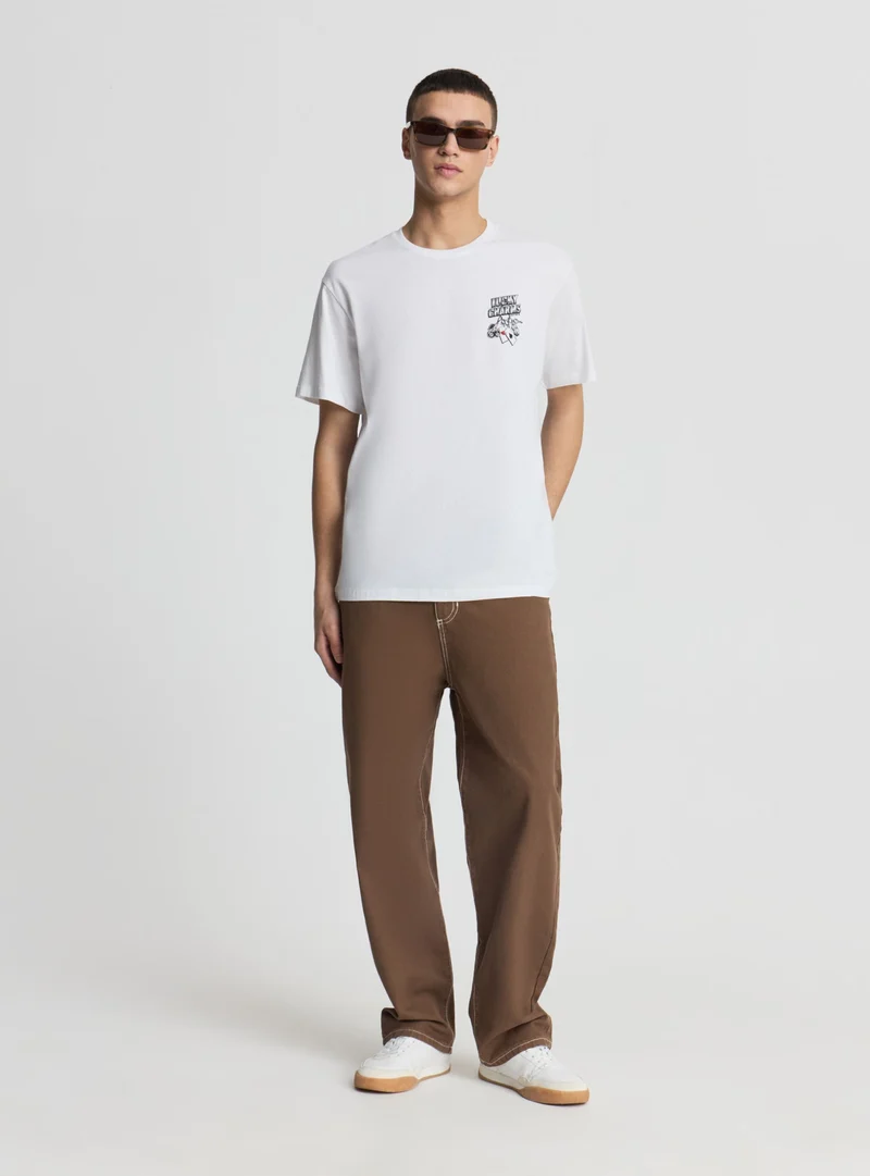 T-shirt con stampa dadi e carte fronte/retro