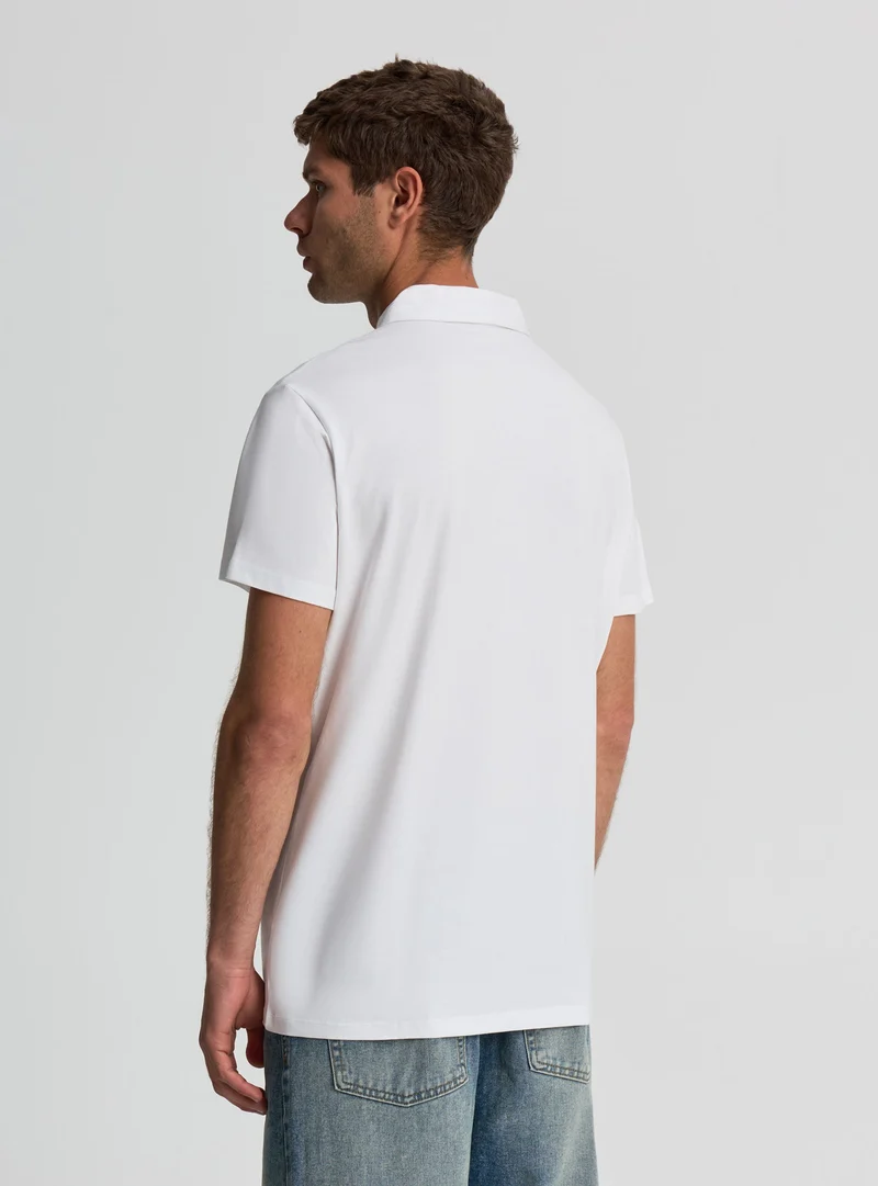 Polo a tinta unita con zip