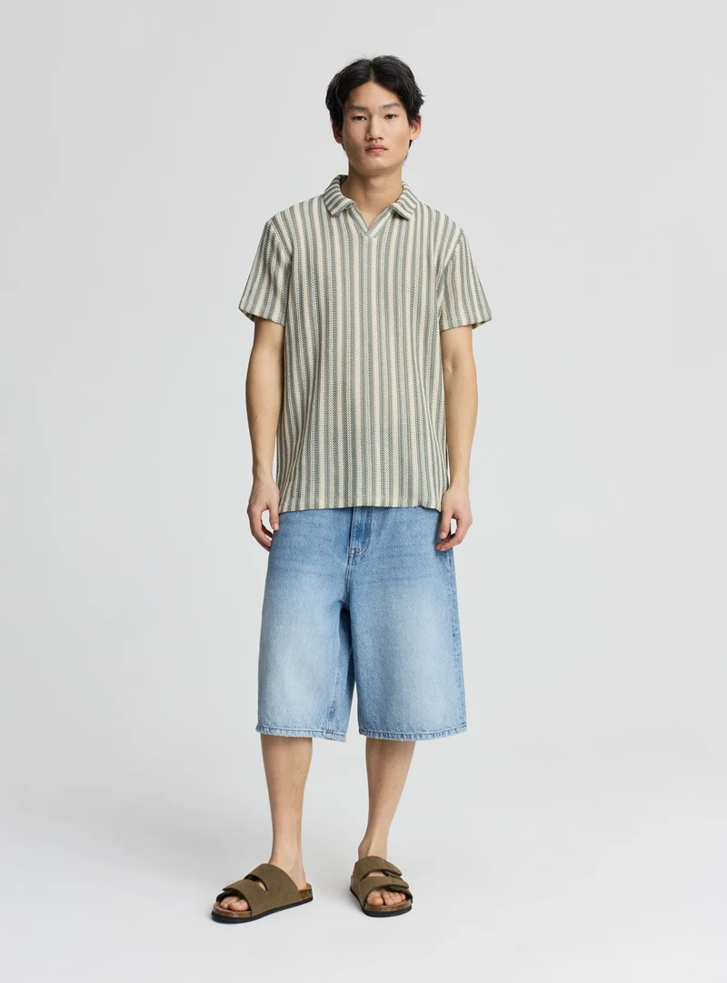 T-shirt polo a righe effetto crochet