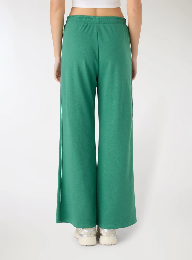 Pantaloni tuta wide leg con bande laterali
