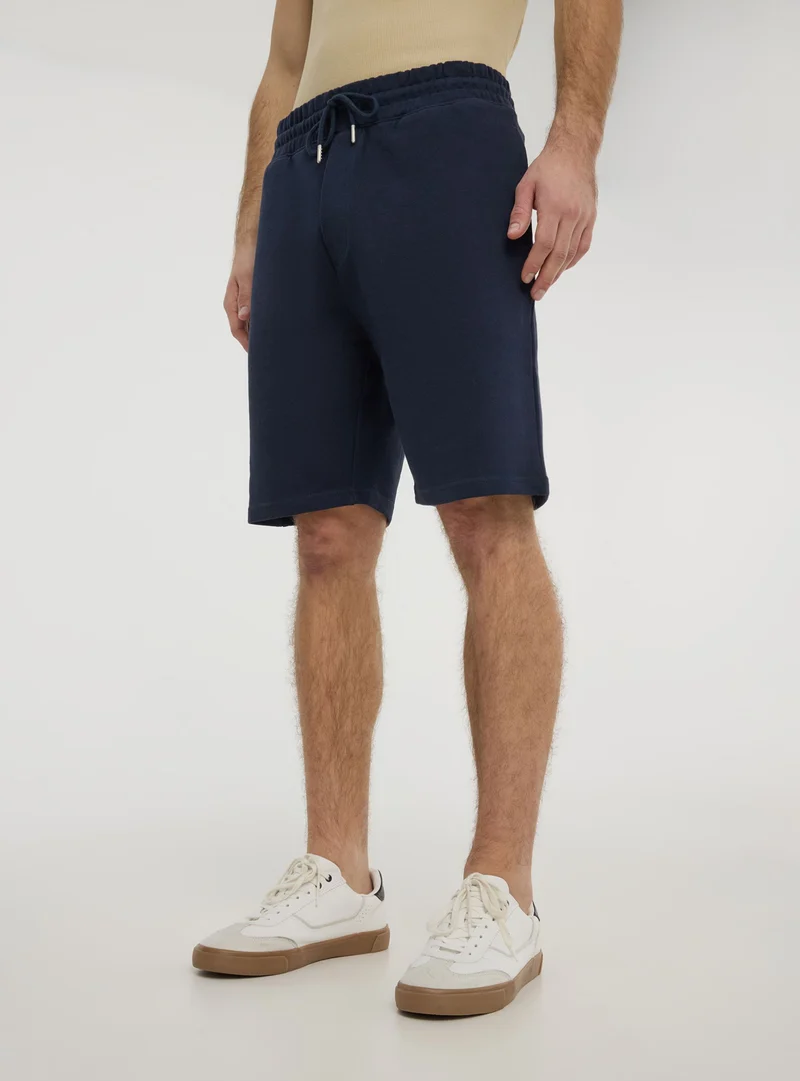 Pantaloncini tuta tinta unita con coulisse
