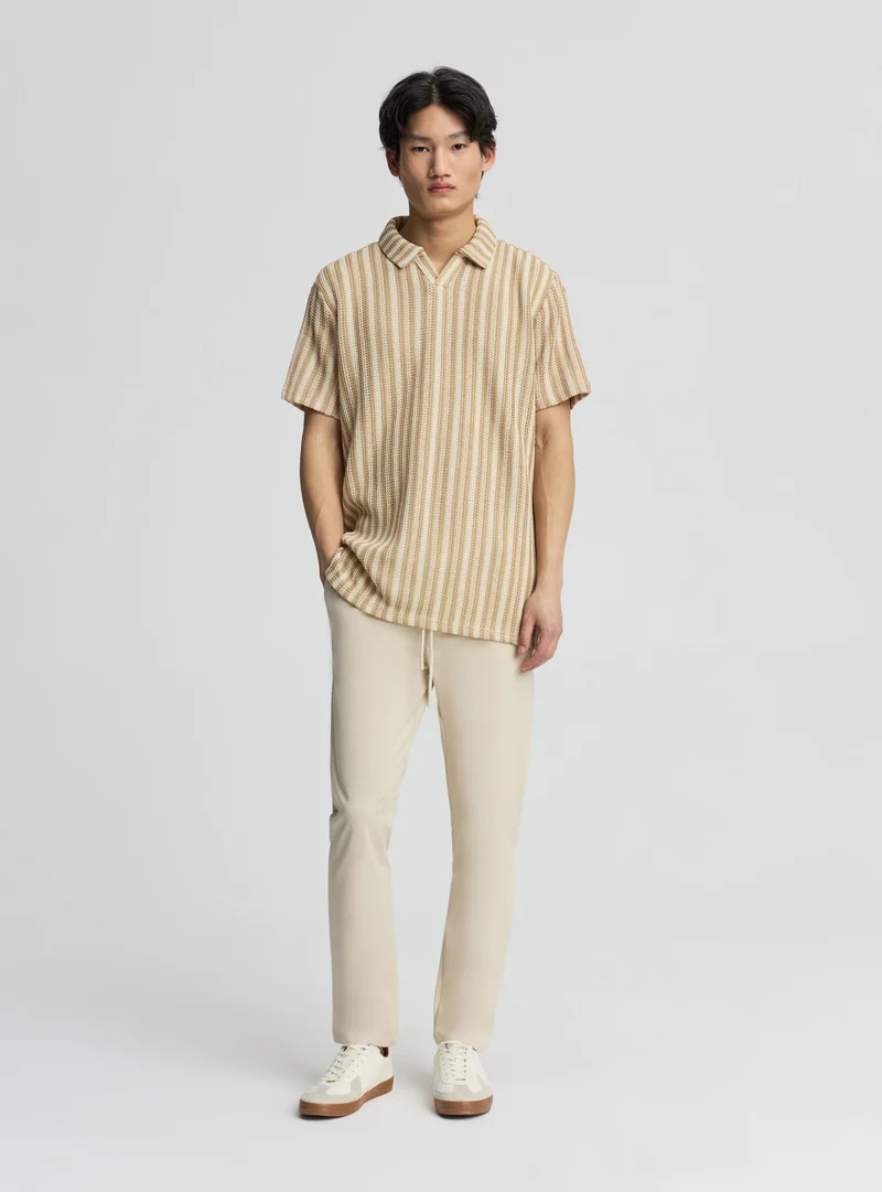 T-shirt polo a righe effetto crochet