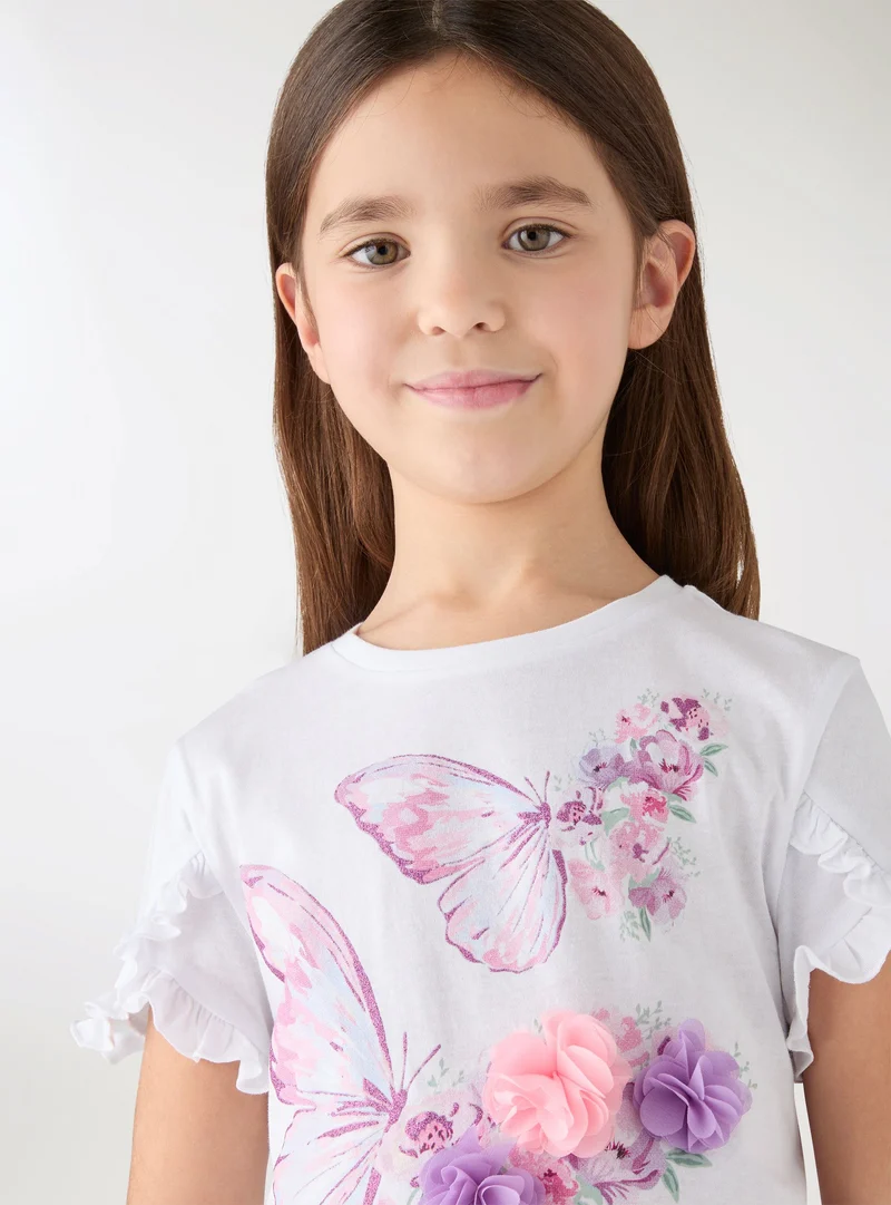 T-shirt con farfalle e applicazioni floreali