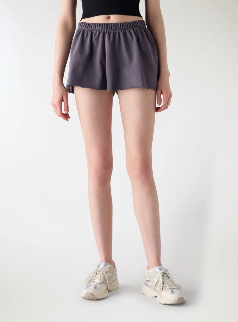 Pantaloncini tuta corti svasati a tinta unita