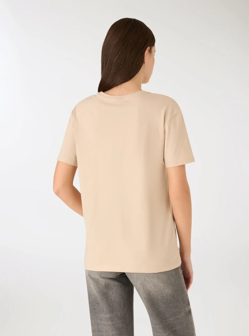 T-shirt con ricamo volto