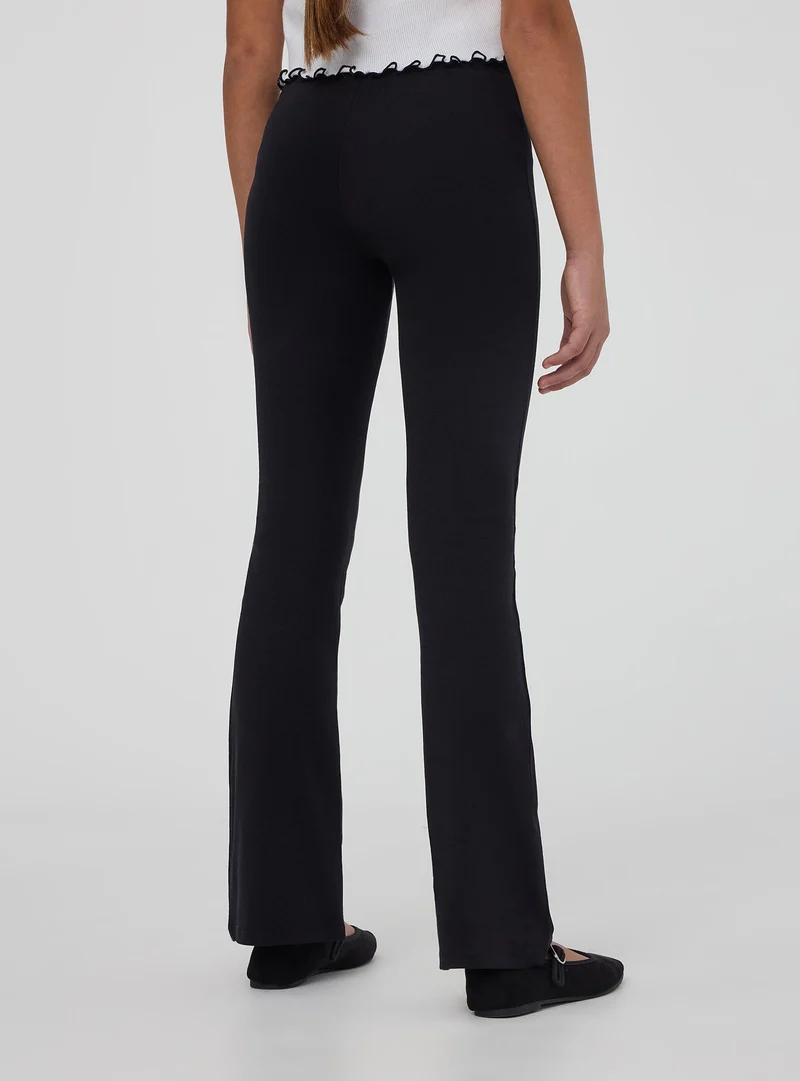 Leggings lunghi a zampa tinta unita