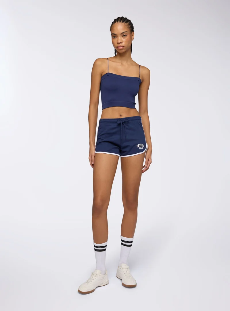 Shorts tuta leggeri con profili e stampa college