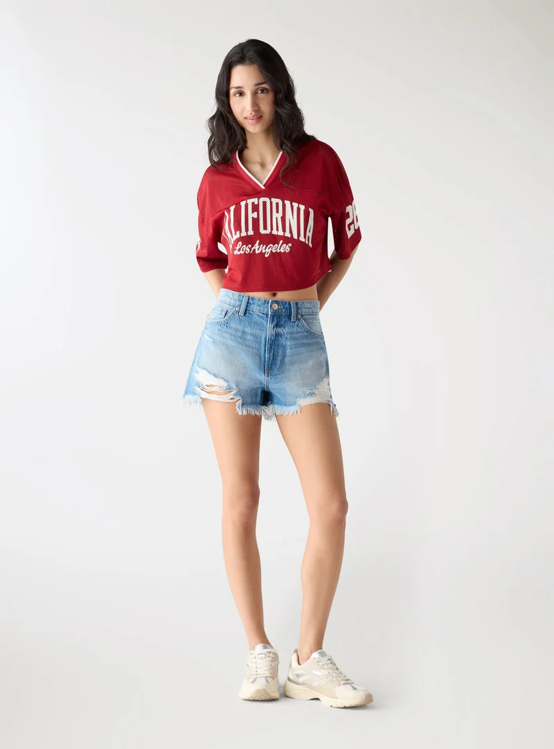 Shorts mom con strappi