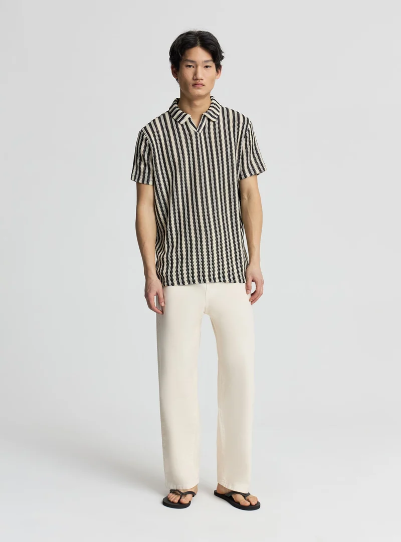 T-shirt polo a righe effetto crochet