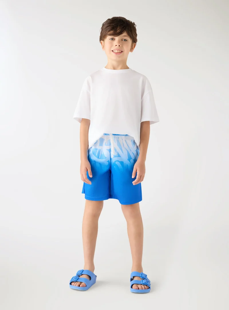 Pantaloncini tuta con stampa graffiti sfumata