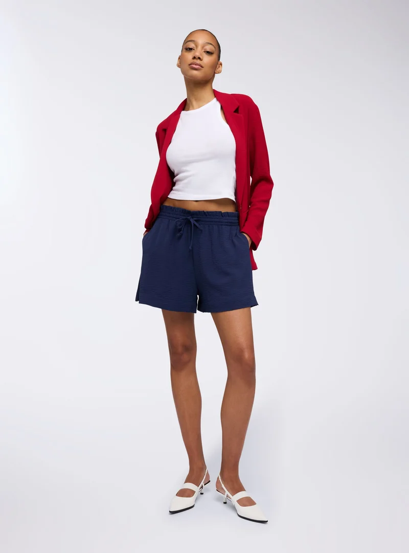 Shorts con coulisse tinta unita