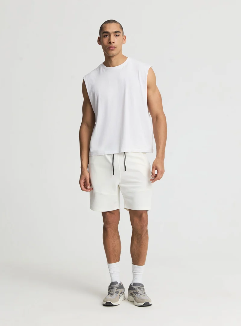 Pantaloni tuta tecnici a tinta unita con zip e tagli