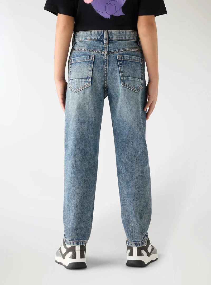Jeans con strappi a tinta unita