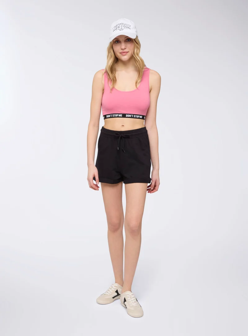 Shorts tuta a vita alta con risvolto
