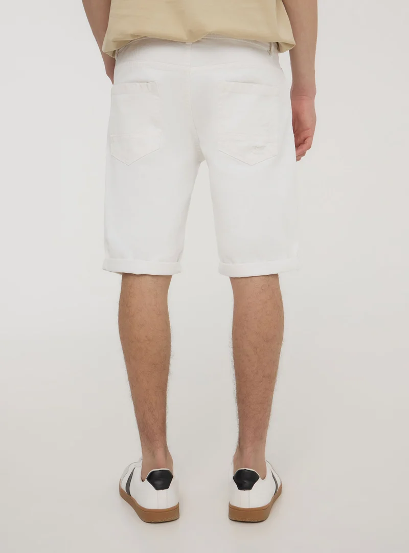 Bermuda in denim con strappi