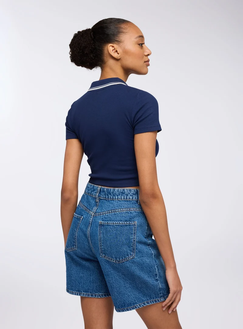 Polo crop con colletto con profili a contrasto