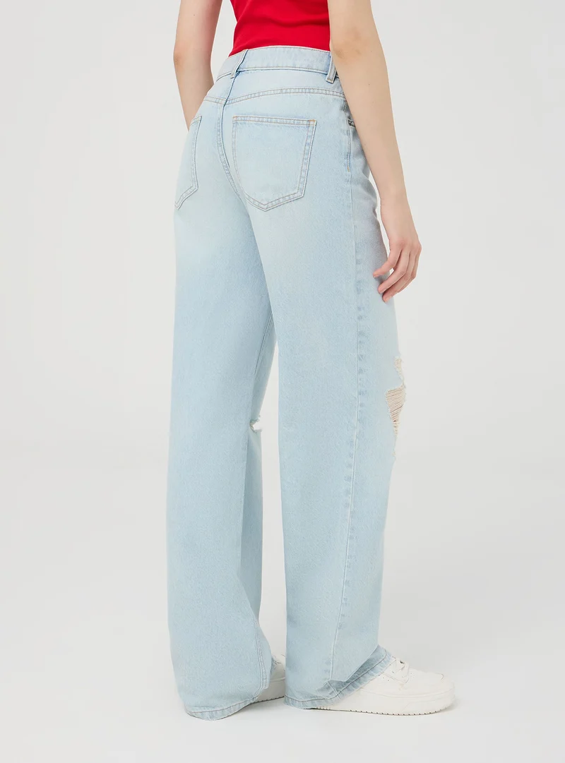 Jeans chiari wide leg con strappi