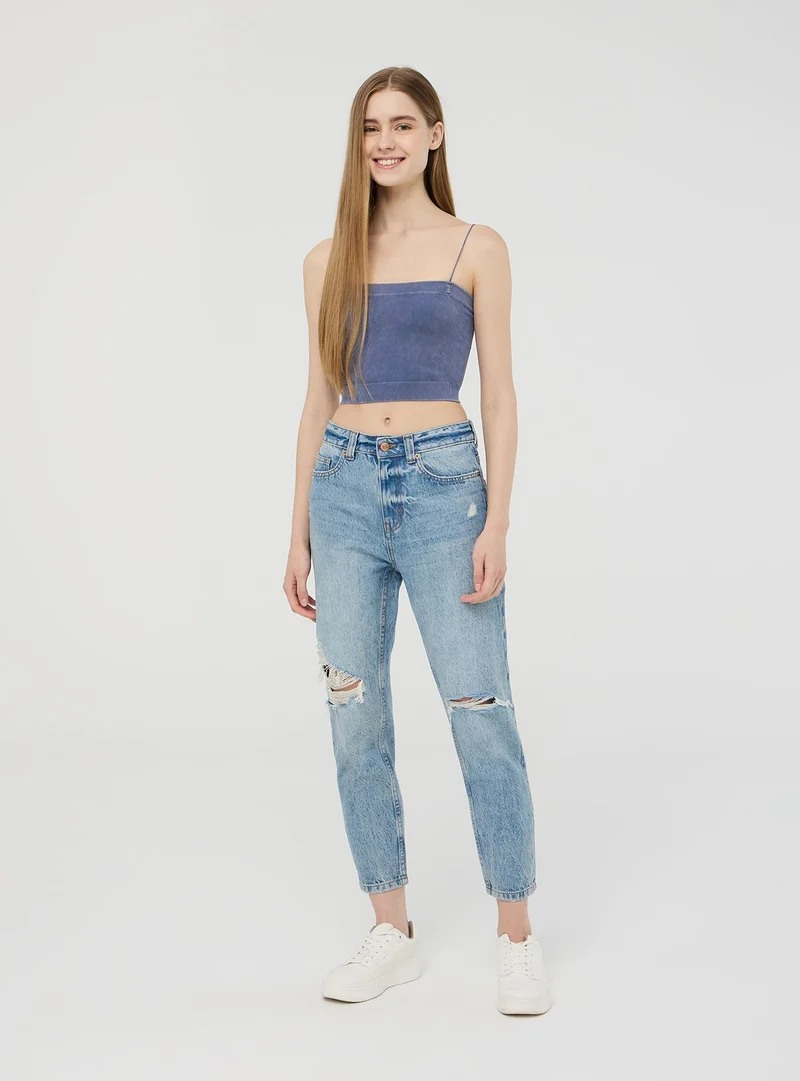 Jeans mom con strappi acid wash