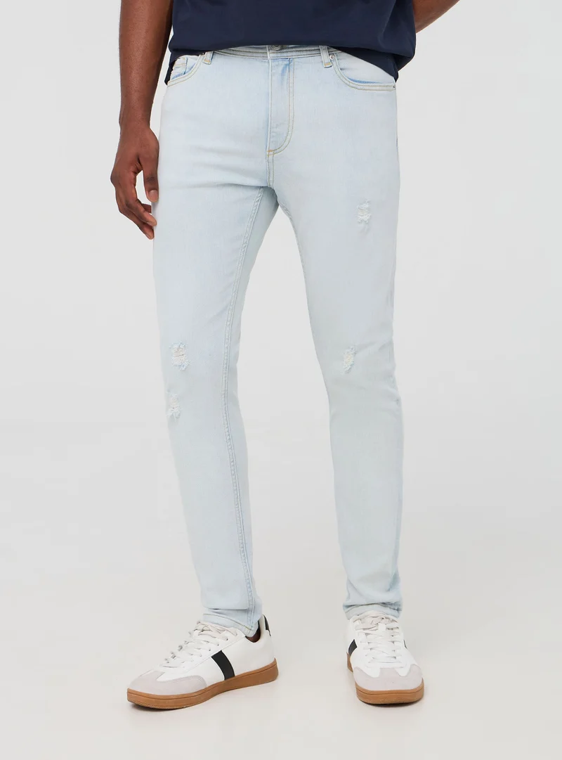 Jeans skinny chiari con strappi