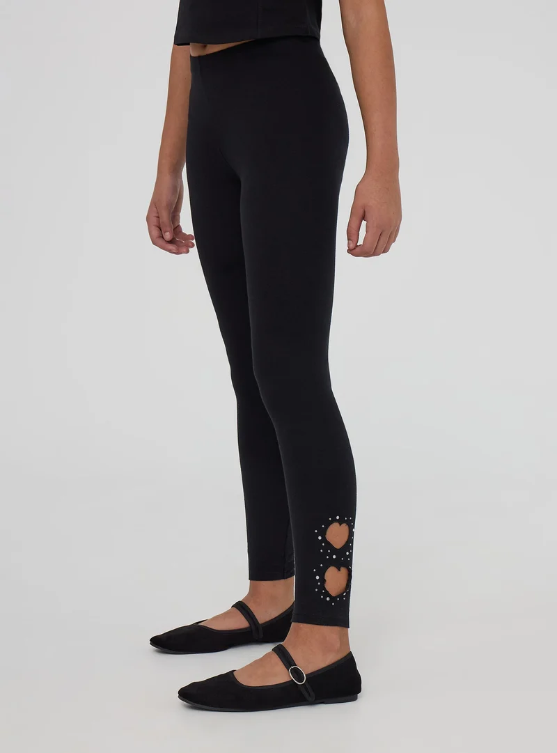 Leggings lunghi con cut-out a cuore e strass