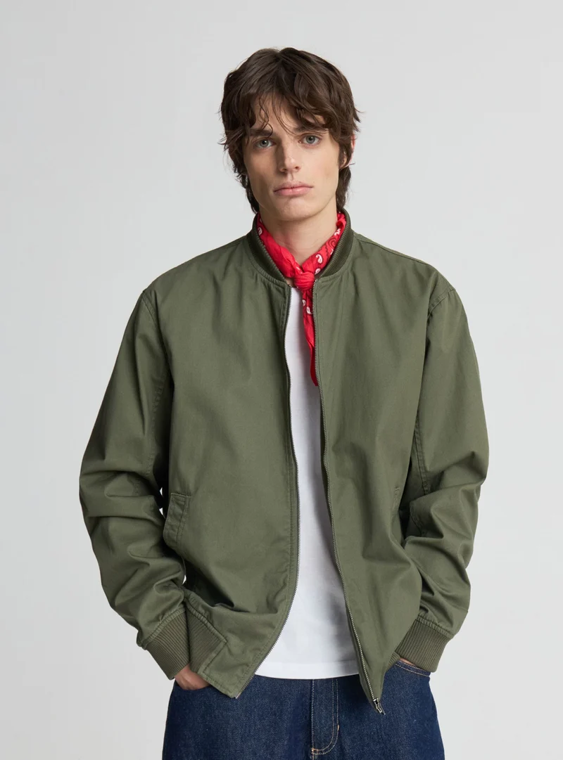 Bomber con zip a tinta unita