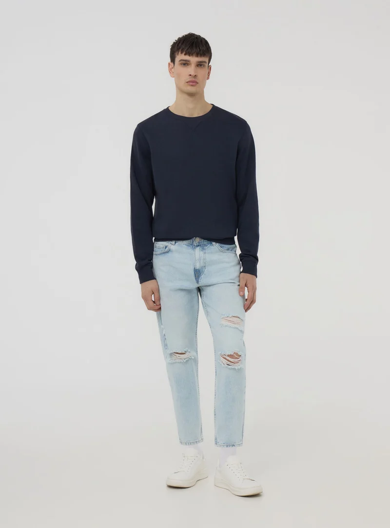 Jeans chiari loose fit con strappi