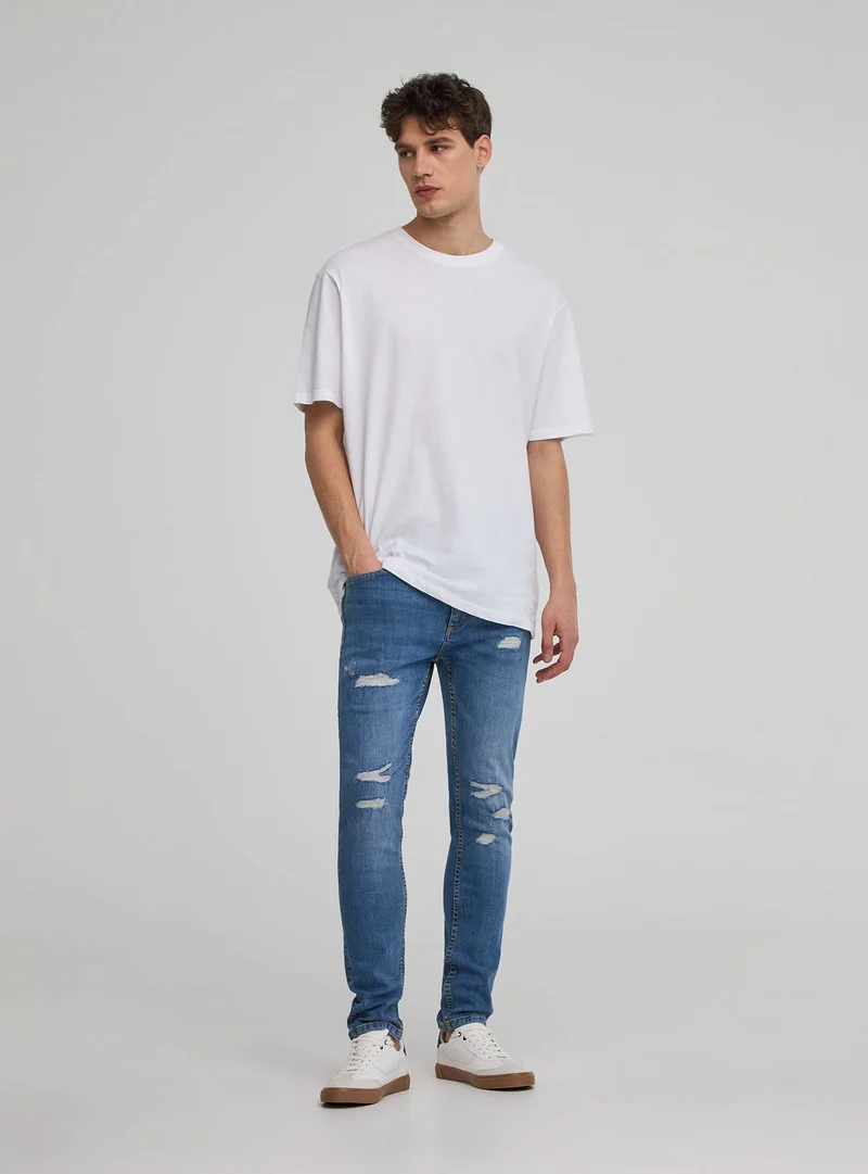 Jeans skinny con strappi