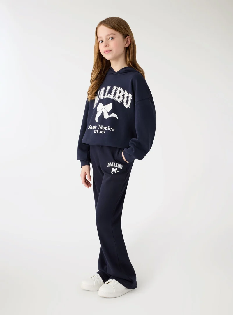 Pantaloni tuta a zampa con stampa college