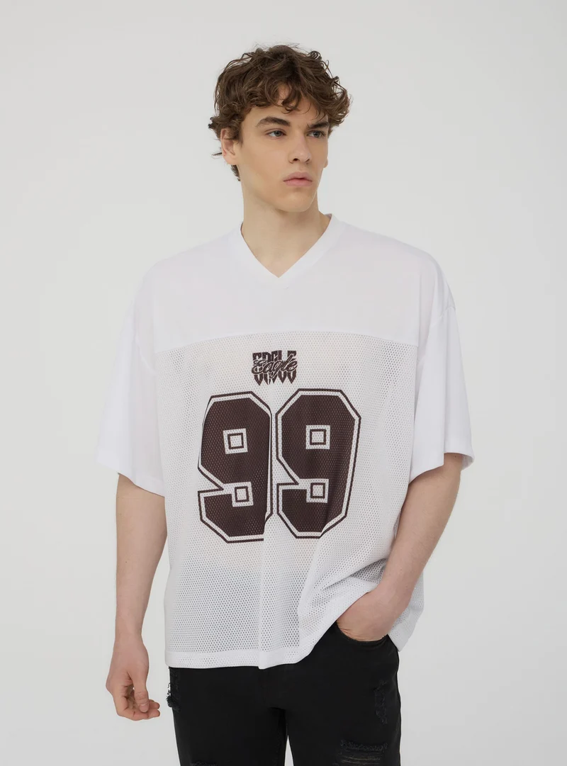 T-shirt a rete tinta unita