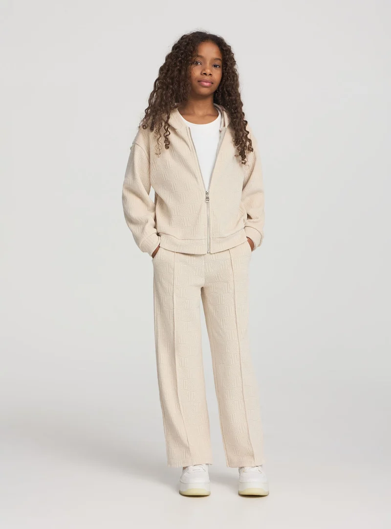 Pantaloni tuta wide leg con lavorazione goffrata