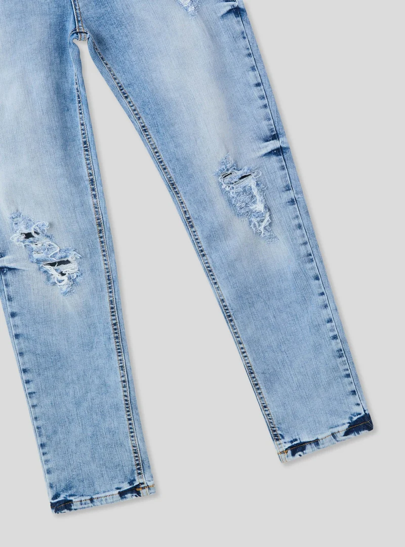 Jeans skinny strappati