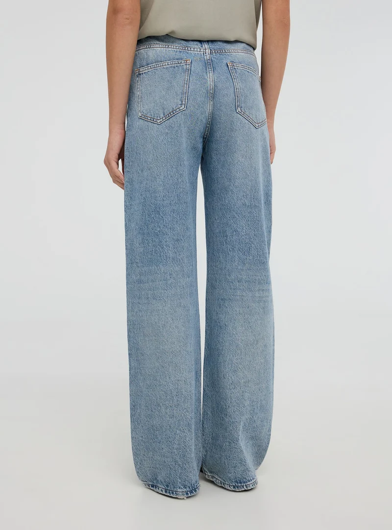 Jeans wide leg con strappi acid wash