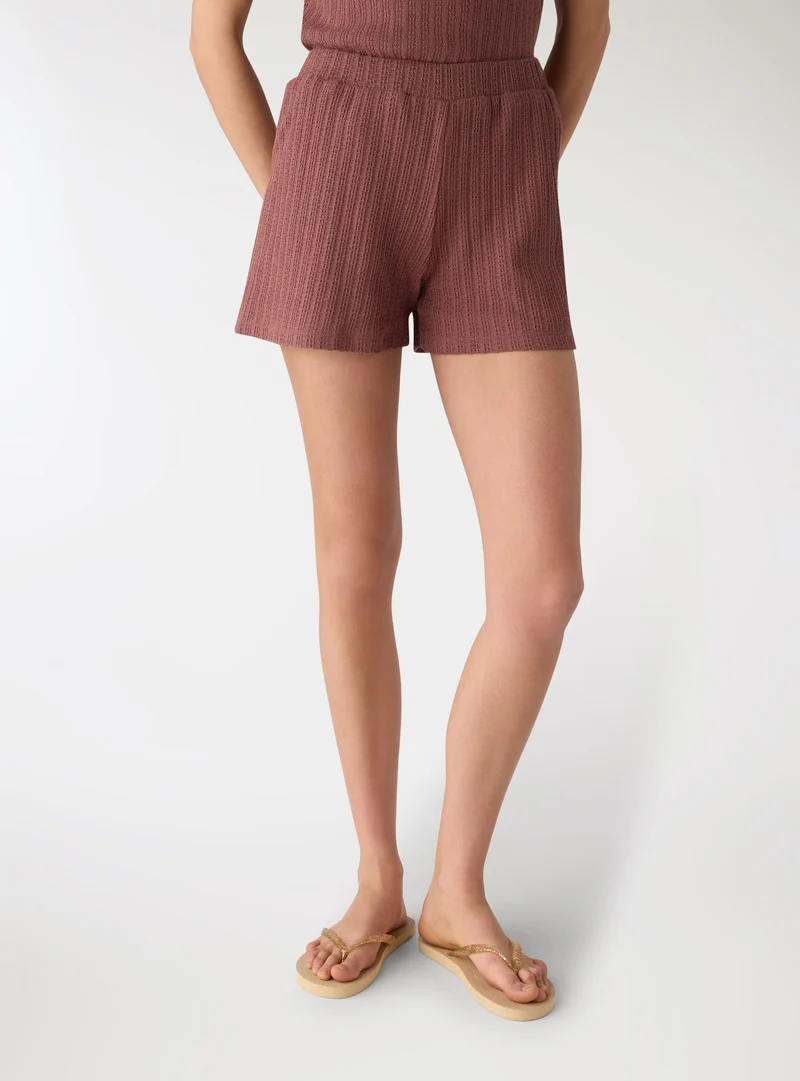 Shorts in maglia a tinta unita con elastico in vita