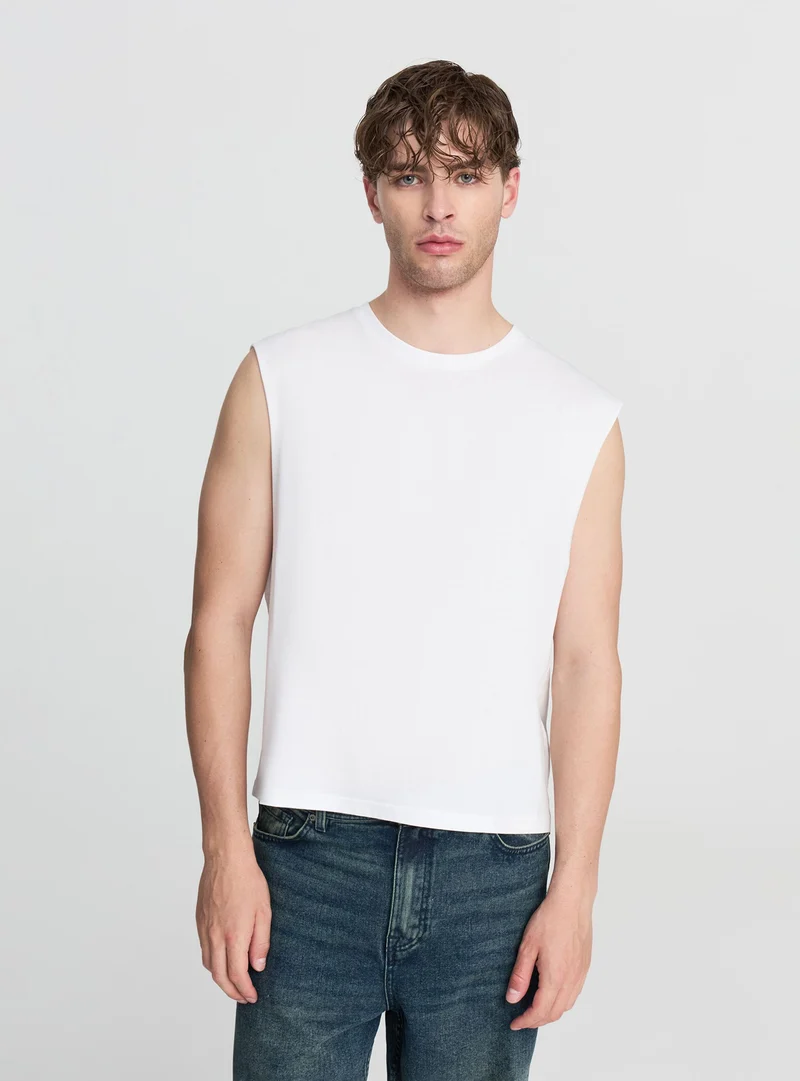 Canotta crop tinta unita smanicata